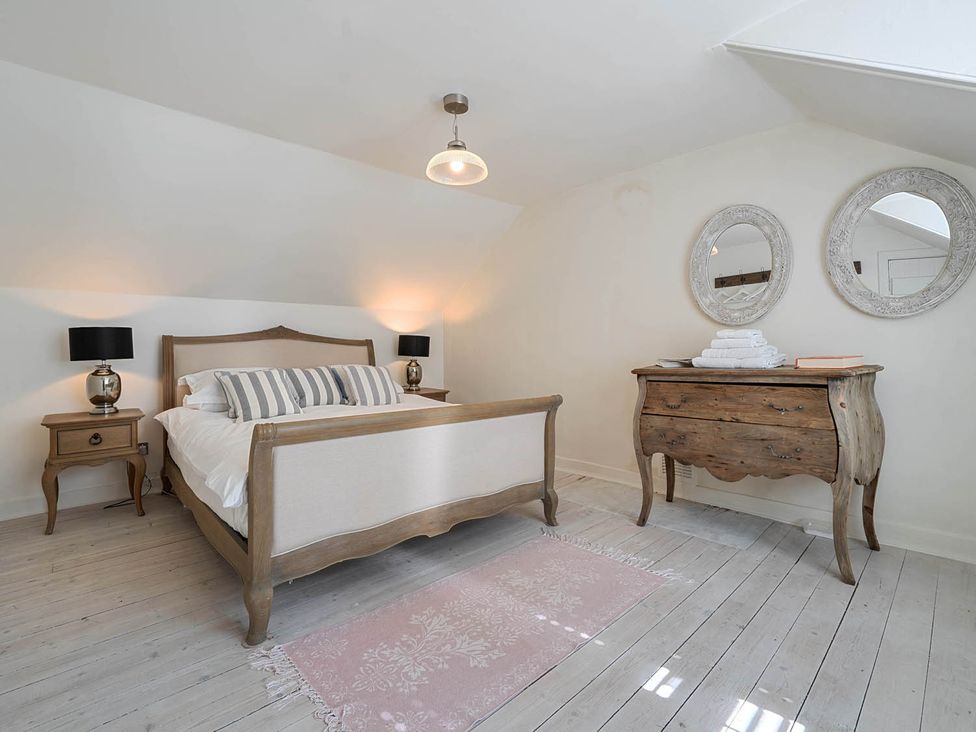 A bedroom with a bed and dresser at House Sleeps 6 Pet Friendly Parking Auchencairn near Palnackie