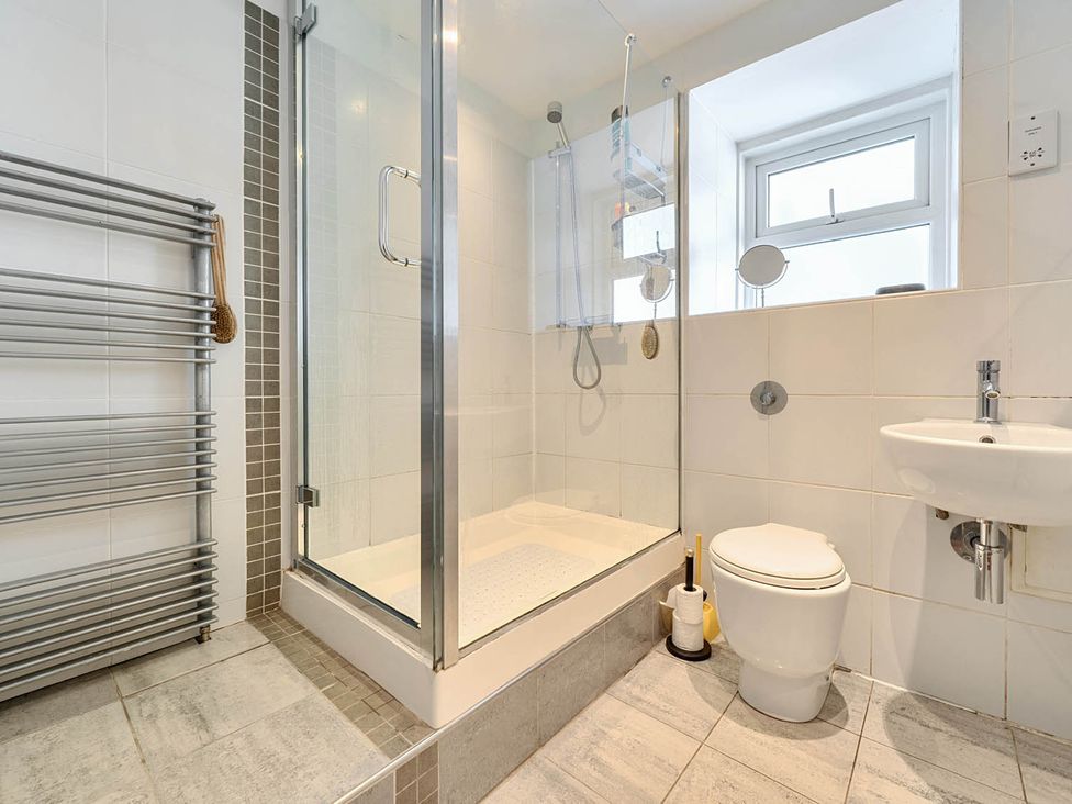 A bathroom with a shower, toilet, and sink at House Sleeps 6 Pet Friendly Parking in Auchencairn near Palnackie