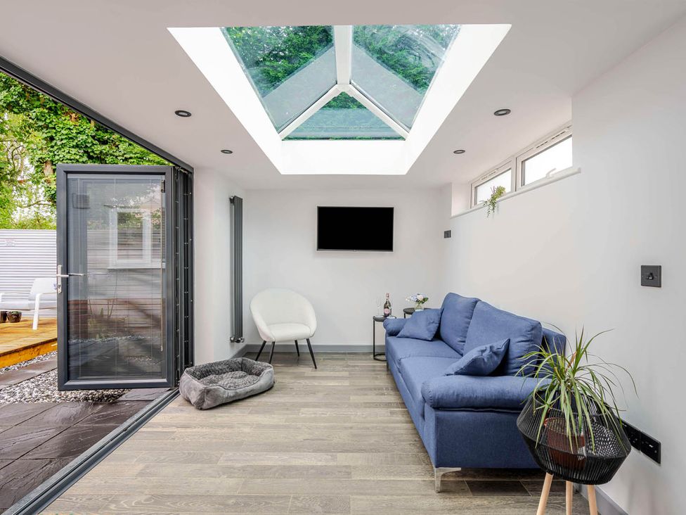 A snug with a sofa and table at Detached House in Quiet Village Pets Allowed, Ashbocking near Otley, Suffolk