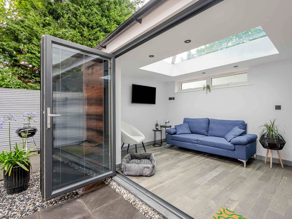 A snug with a sofa and armchair at Detached House in Quiet Village Pets Allowed Ashbocking near Otley, Suffolk