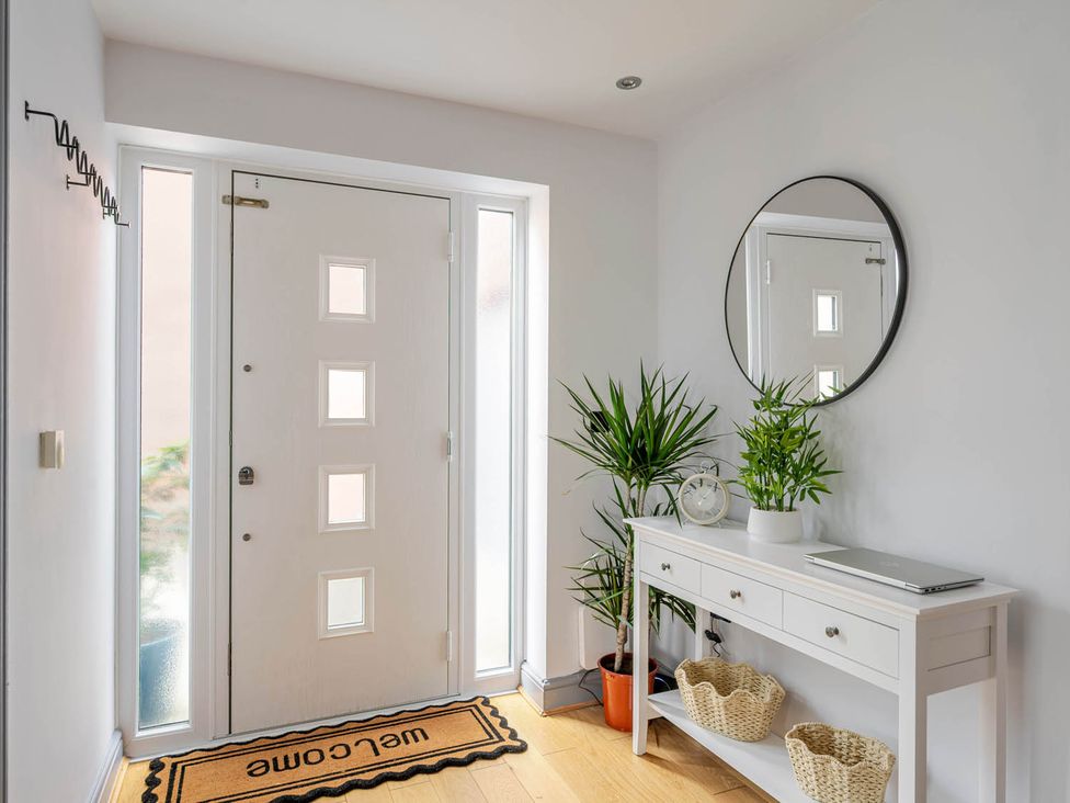 A hallway with a front door and console table at Detached House in Quiet Village Pets Allowed Ashbocking near Otley, Suffolk