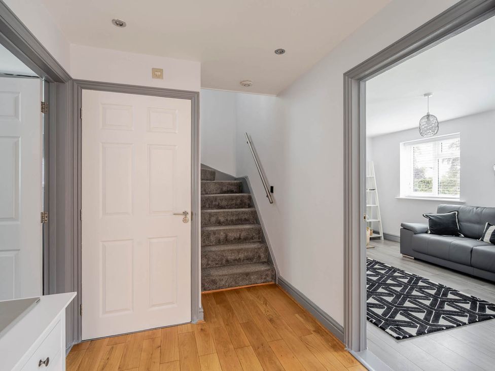 A hallway with a staircase and doors at Detached House in Quiet Village Pets Allowed Ashbocking near Otley, Suffolk