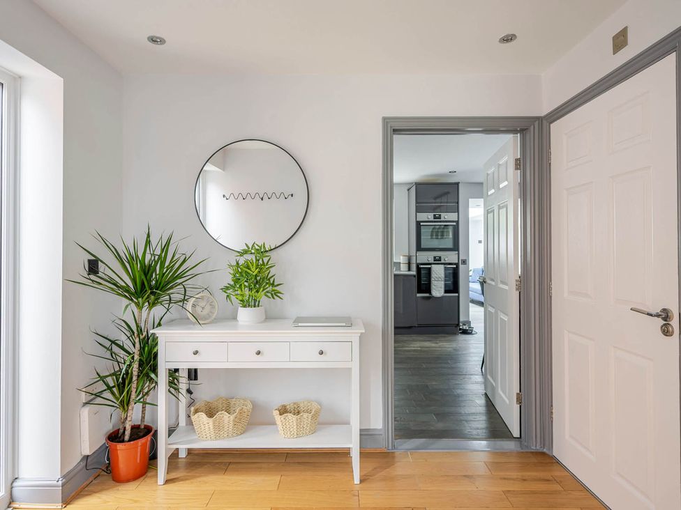 A hallway with a side table and plants at Detached House in Quiet Village Pets Allowed Ashbocking near Otley, Suffolk