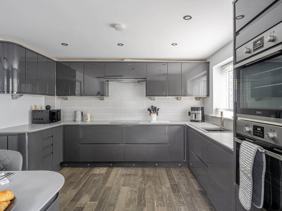 A kitchen with modern cabinets and appliances at Detached House in Quiet Village Pets Allowed Ashbocking near Otley, Suffolk