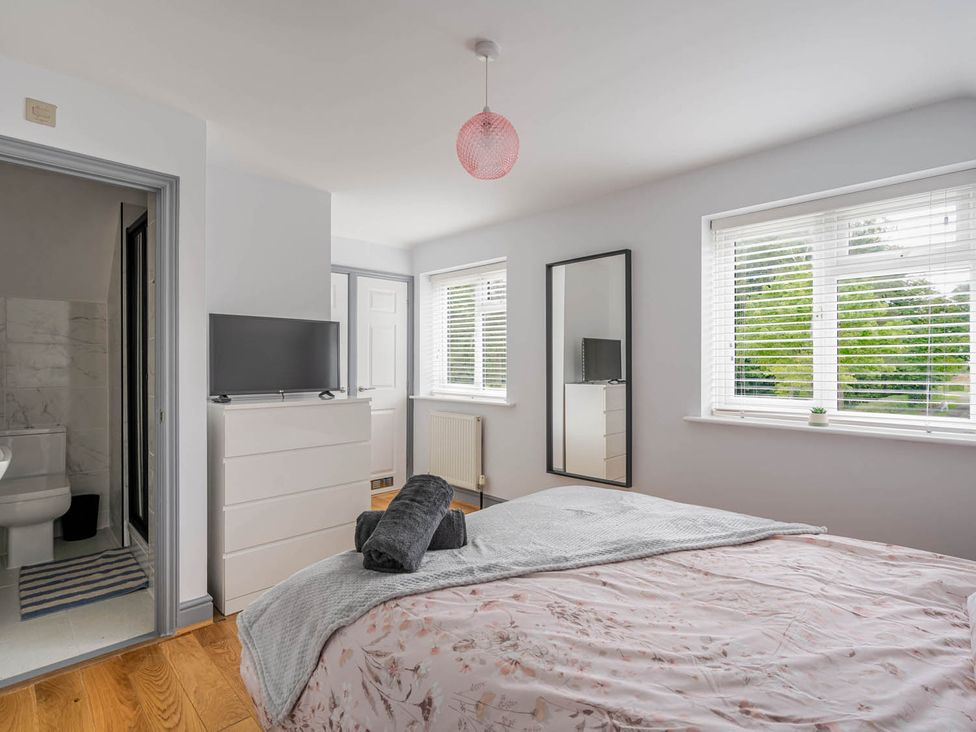 A bedroom with a bed and television at Detached House in Quiet Village Pets Allowed Ashbocking near Otley, Suffolk