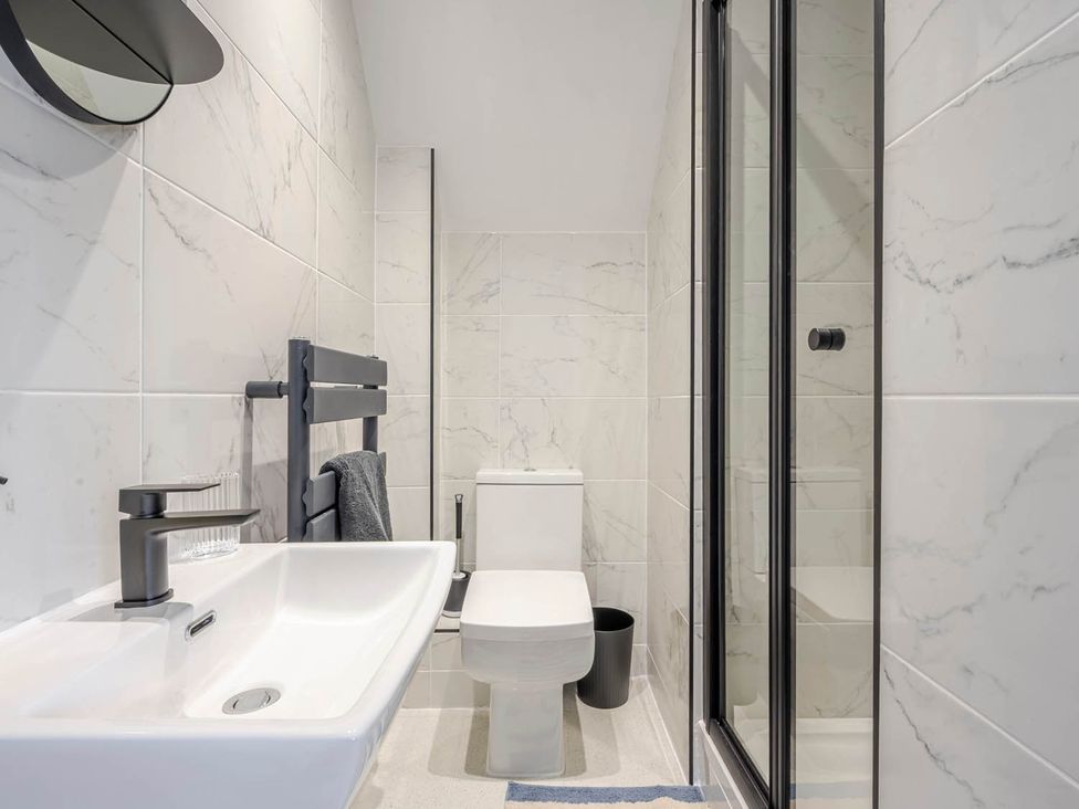 A bathroom with a sink, toilet, shower and mirror at Detached House in Quiet Village Pets Allowed Ashbocking near Otley, Suffolk