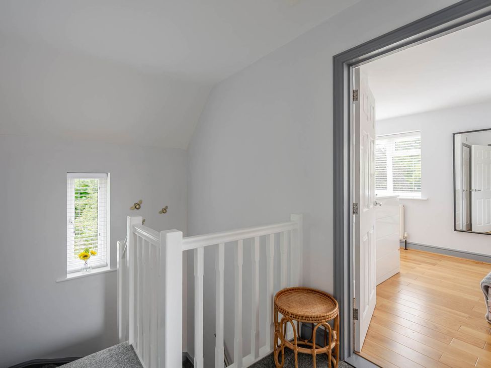 A landing area with stairs and a window at Detached House in Quiet Village Pets Allowed Ashbocking near Otley, Suffolk