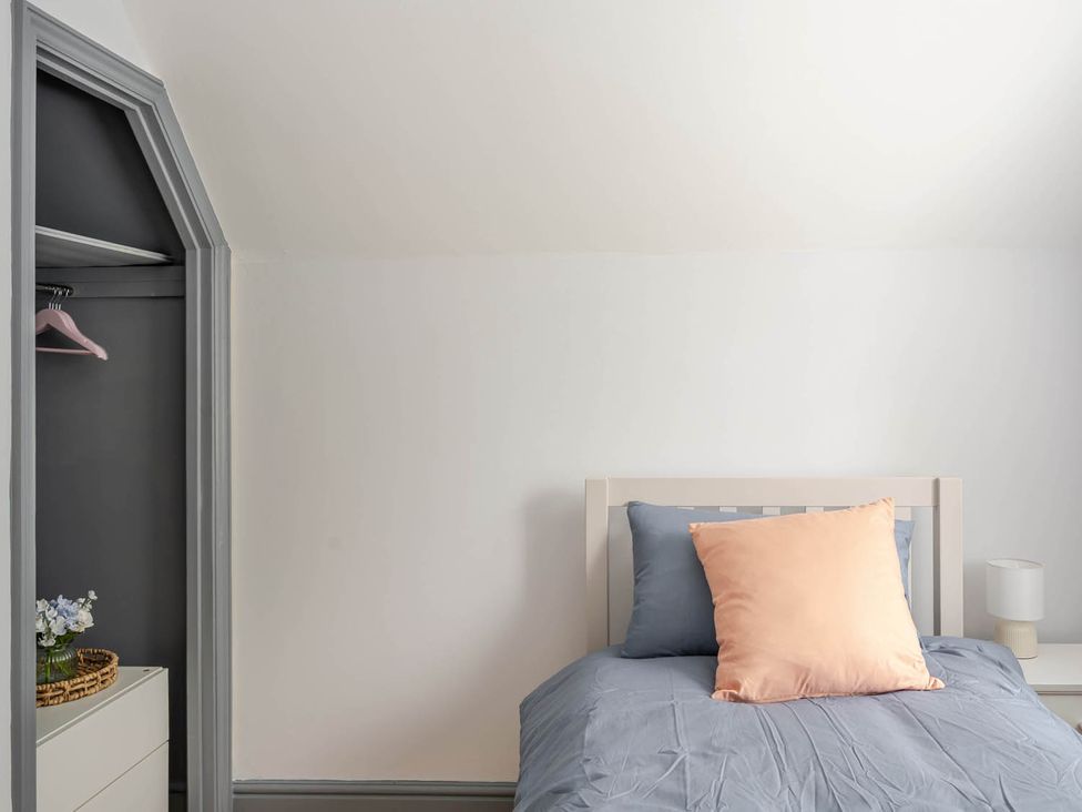 A bedroom with a bed and closet at Detached House in Quiet Village Pets Allowed, Ashbocking near Otley, Suffolk