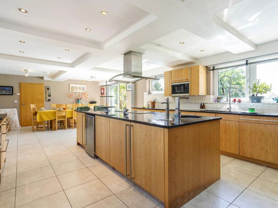 A kitchen with an island and dining area at Sleeps 10 to 18 Parking Garden Pool Hot Tub Balcony Friston