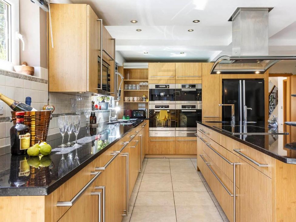 A kitchen with appliances and a countertop at Sleeps 10 to 18 Parking Garden Pool Hot Tub Balcony in Friston