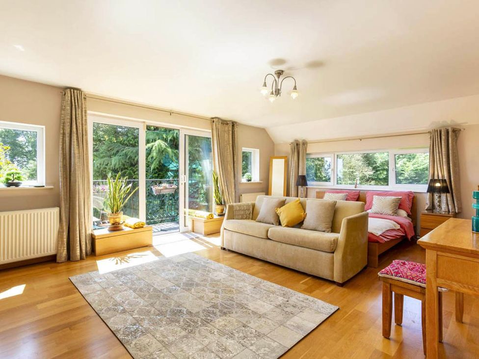 A living room with a sofa and table at Sleeps 10 to 18 Parking Garden Pool Hot Tub Balcony in Friston