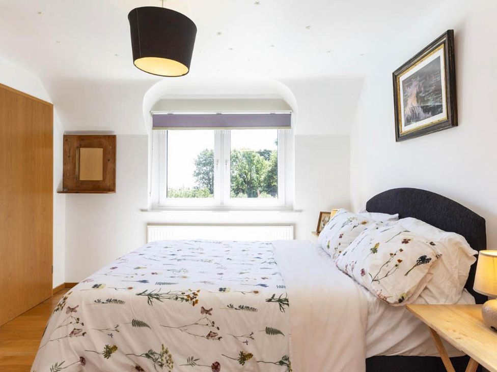 A bedroom with a bed and window at Sleeps 10 to 18 Parking Garden Pool Hot Tub Balcony in Friston