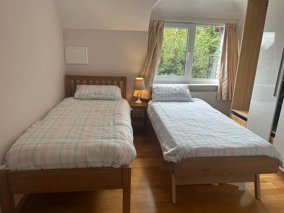 A bedroom with two beds and a lamp at Sleeps 10 to 18 Parking Garden Pool Hot Tub Balcony in Friston