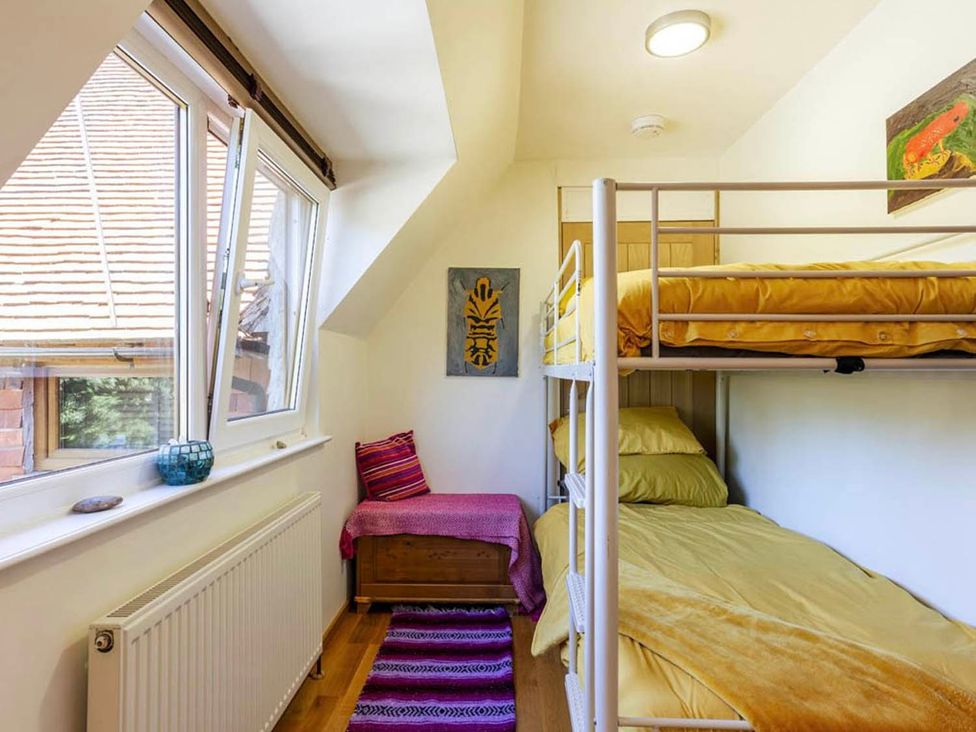 A bedroom with a bunk bed and artwork at Sleeps 10 to 18 Parking Garden Pool Hot Tub Balcony in Friston