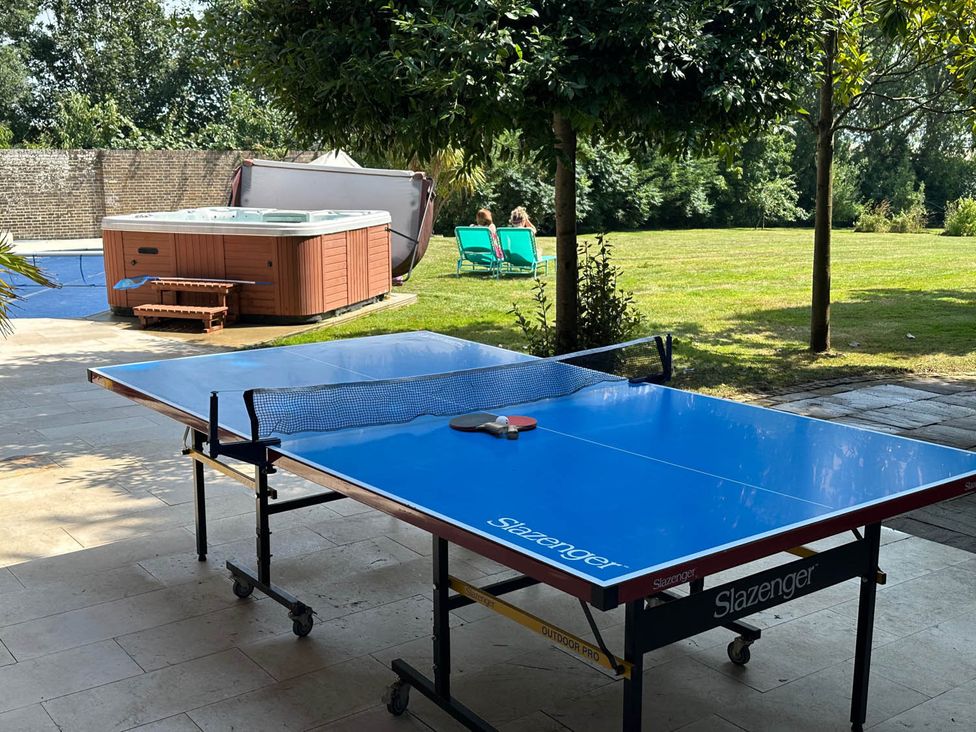 An outdoor area with a ping pong table and a hot tub at Sleeps 10 to 18 Parking Garden Pool Hot Tub Balcony in Friston