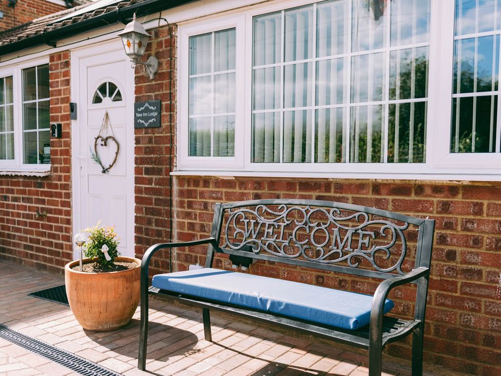 A welcome bench and planter outside at New Inn Lodge Dereham