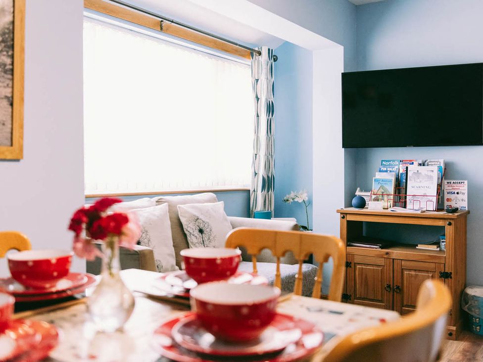 A dining room with a table set and a television at 1 Bed Sleeps 3 Free Parking Pets Allowed in Dereham