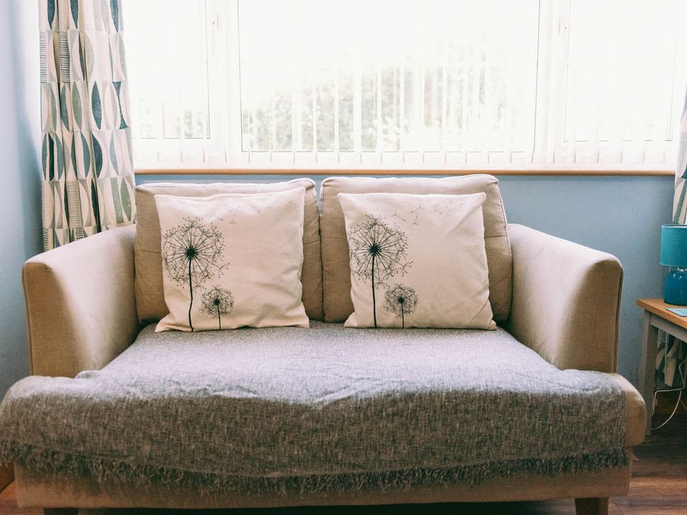 A couch with cushions in a living room at 1 Bed Sleeps 3 Free Parking Pets Allowed in Dereham