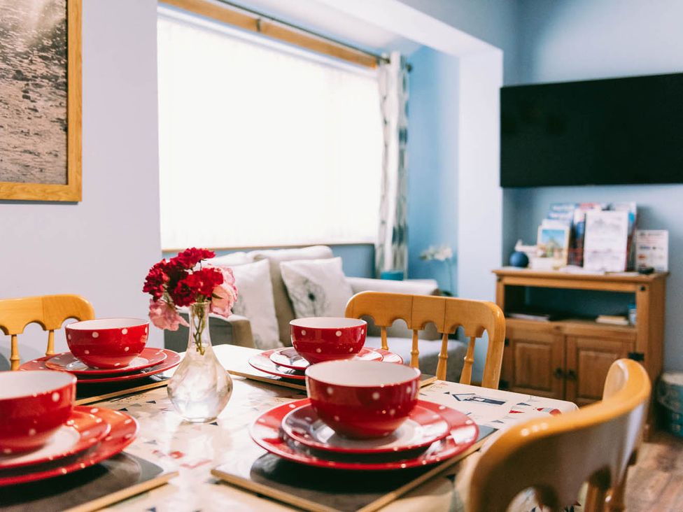 A dining room with a table set and a television at 1 Bed Sleeps 3 Free Parking Pets Allowed in Dereham