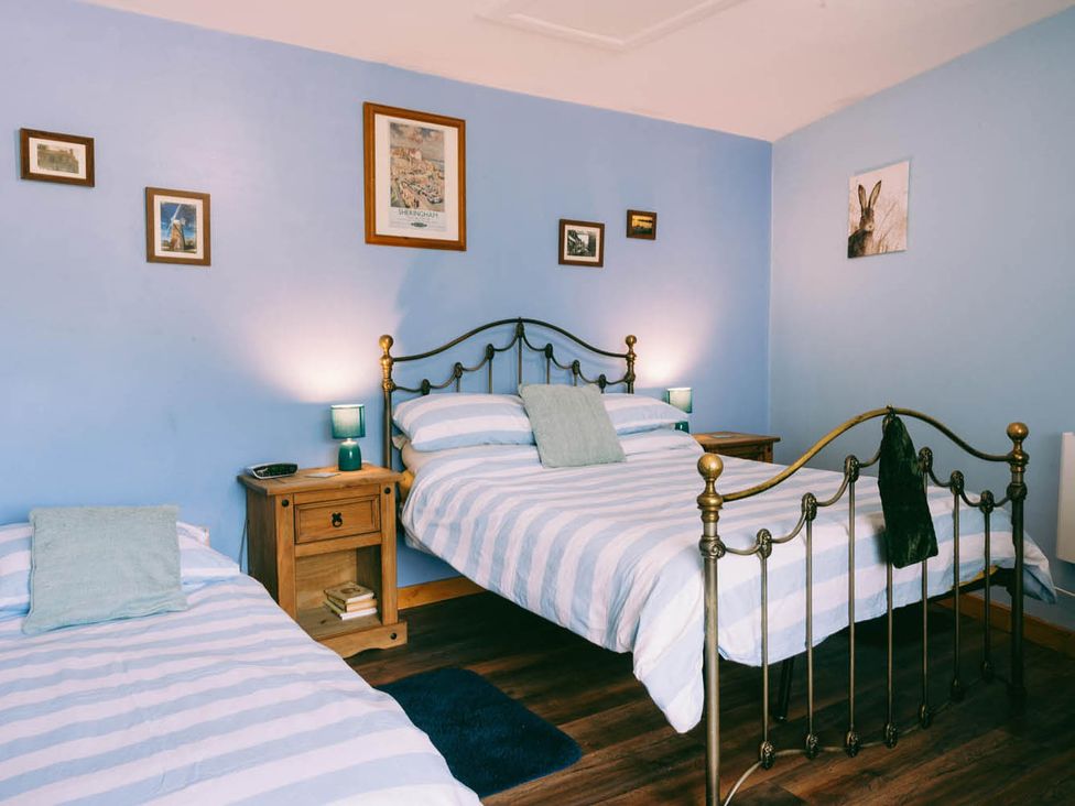 A bedroom with two beds and pictures on the wall at 1 Bed Sleeps 3 Free Parking Pets Allowed in Dereham