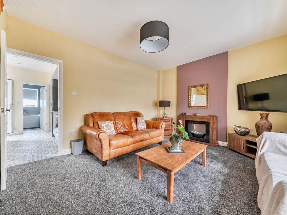 A living room with a sofa and coffee table at Cottage Sleeps 6 with Parking and Garden in Bridlington