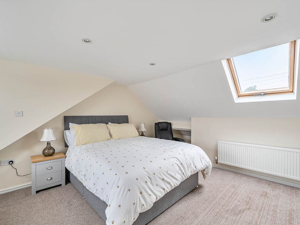 A bedroom with a bed and desk at Cottage Sleeps 6 with Parking and Garden in Bridlington