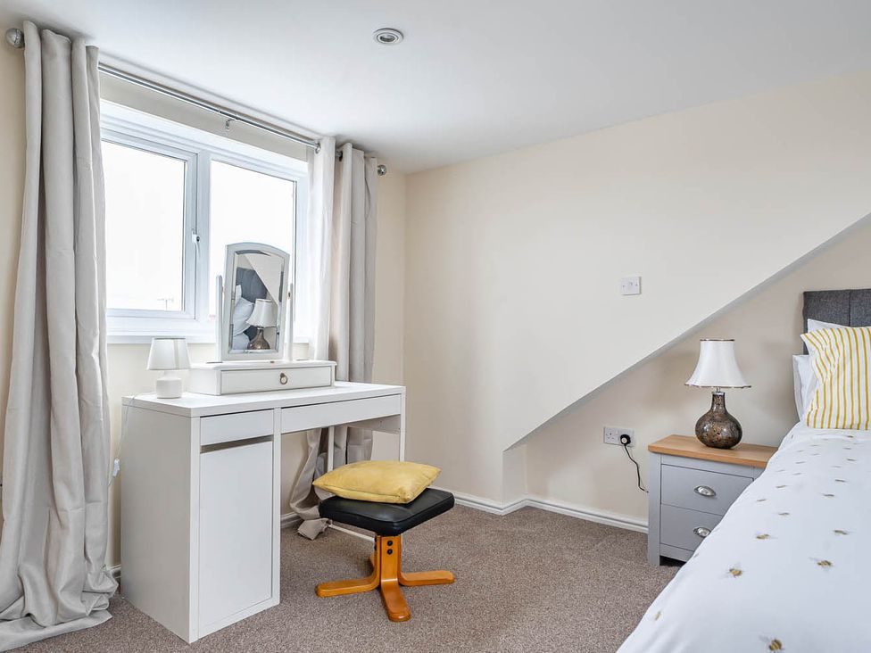 A bedroom with a vanity table and lamp at Cottage Sleeps 6 with Parking and Garden Bridlington