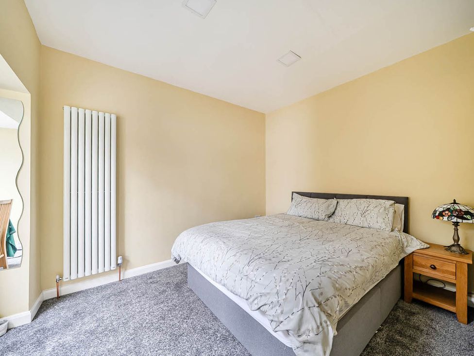 A bedroom with a bed and bedside table at Cottage Sleeps 6 with Parking and Garden in Bridlington