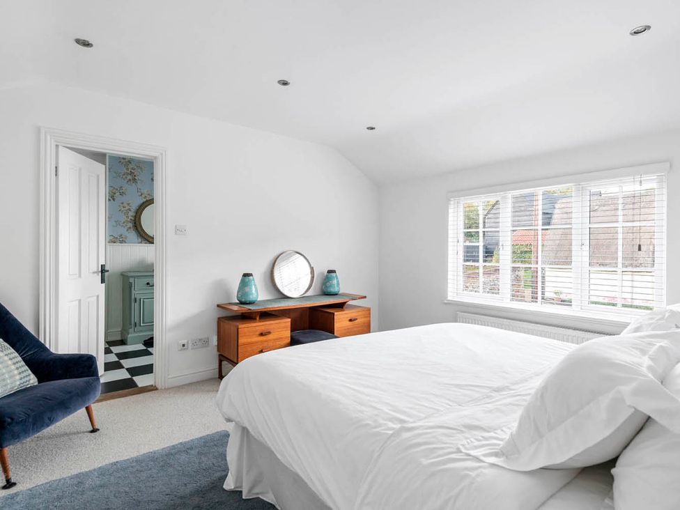 A bedroom with a bed, desk, and chair at a property in an unspecified location