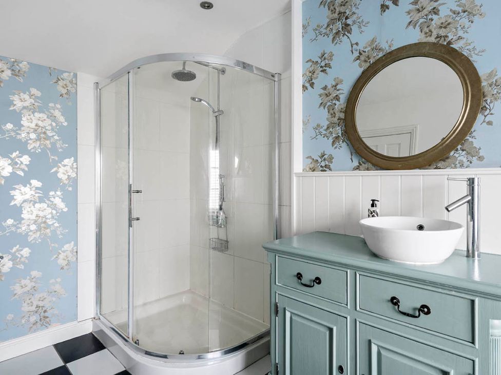 A bathroom with a shower and vanity with a sink at The Old Barn in Manchester