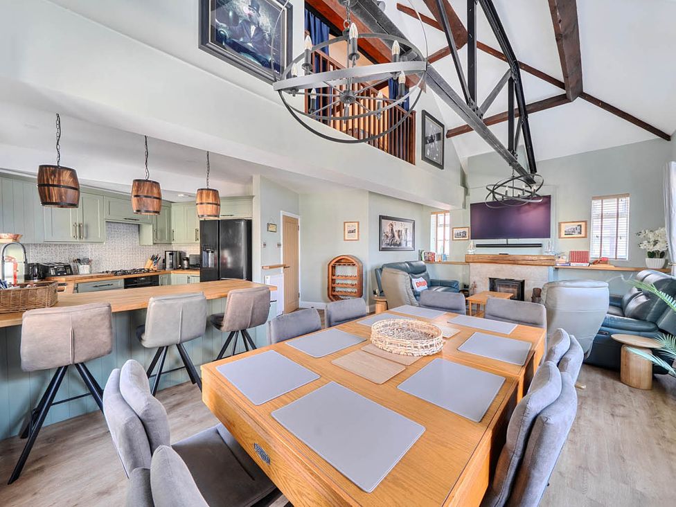 A dining area with a table and chairs at 4 Bed Sleeps 8 Pool Table Sea View Parking in Swanage