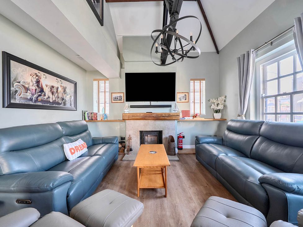 A living room with a sofa and coffee table at 4 Bed Sleeps 8 Pool Table Sea View Parking in Swanage