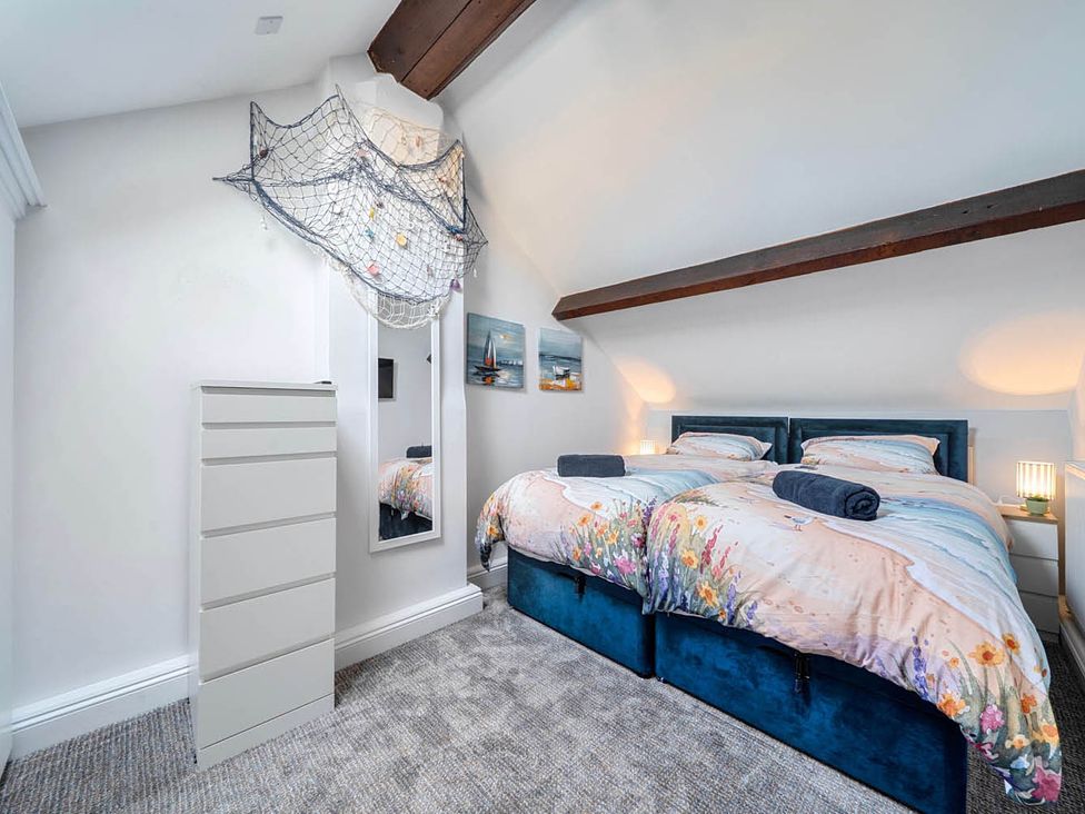 A bedroom with two beds and a chest of drawers at 4 Bed Sleeps 8 Pool Table Sea View Parking in Swanage