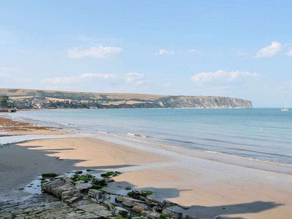 A beach scene with water and cliffs at 4 Bed Sleeps 8 Pool Table Sea View Parking in Swanage