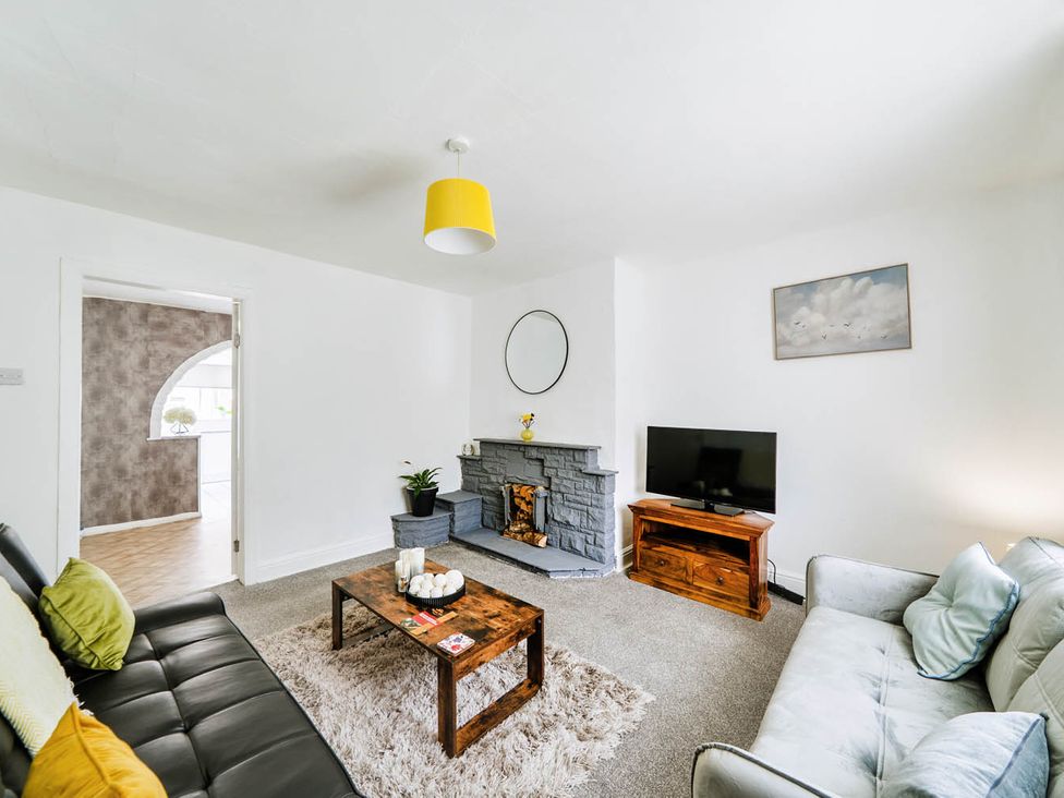 A living room with a coffee table and television at the property in the location