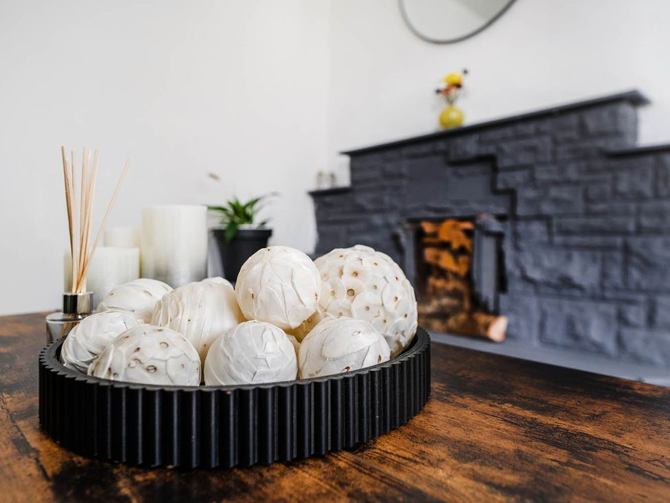 A coffee table with decorative balls and candles in a living room at the property