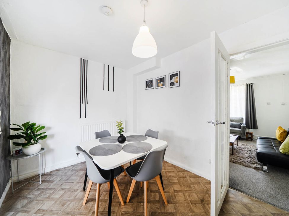 A dining room with a table and chairs at a property