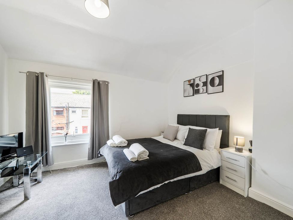 A bedroom with a bed and a television at the property