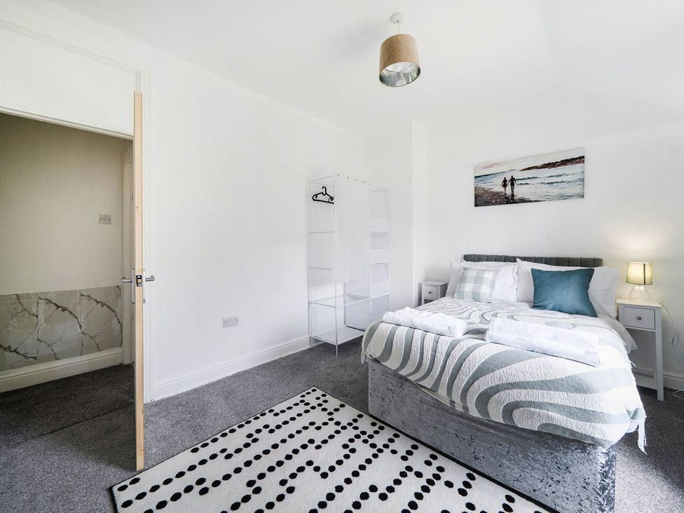 A bedroom with a bed and nightstand at The Old Barn in Manchester