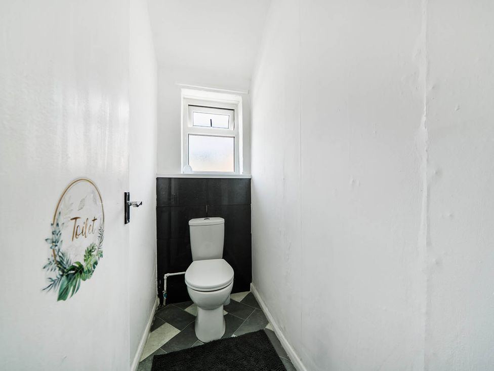 A bathroom with a toilet and a window at 