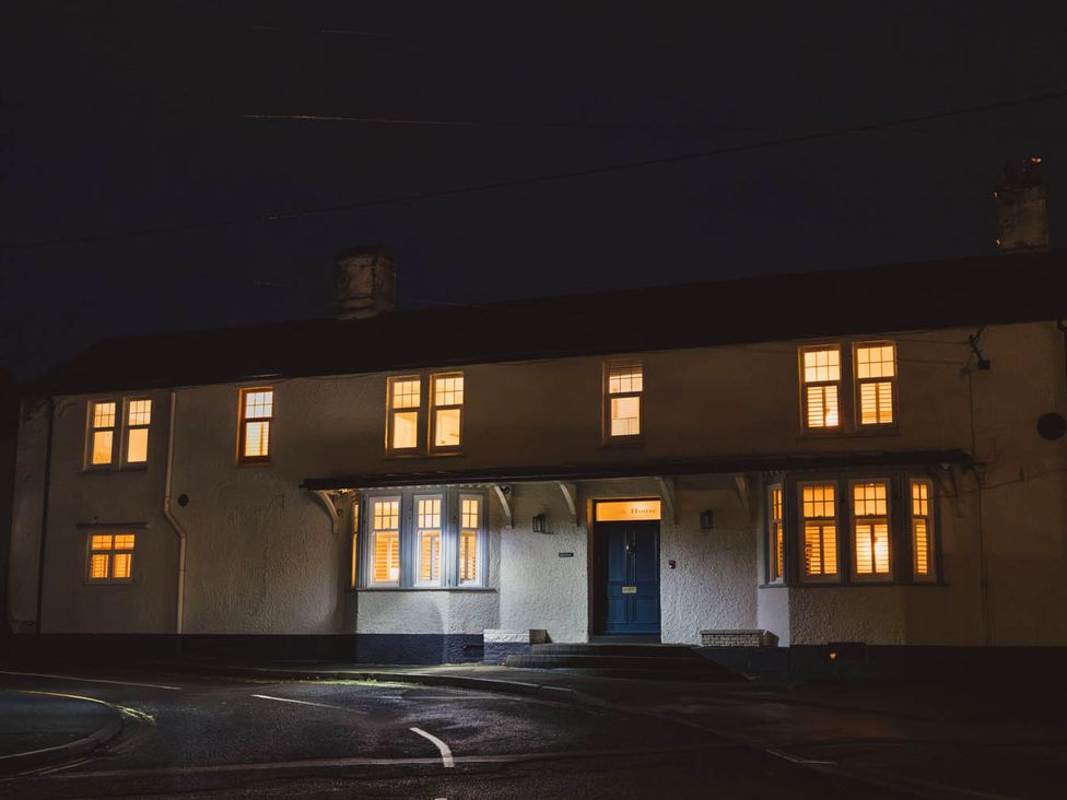 A house with lit windows at night