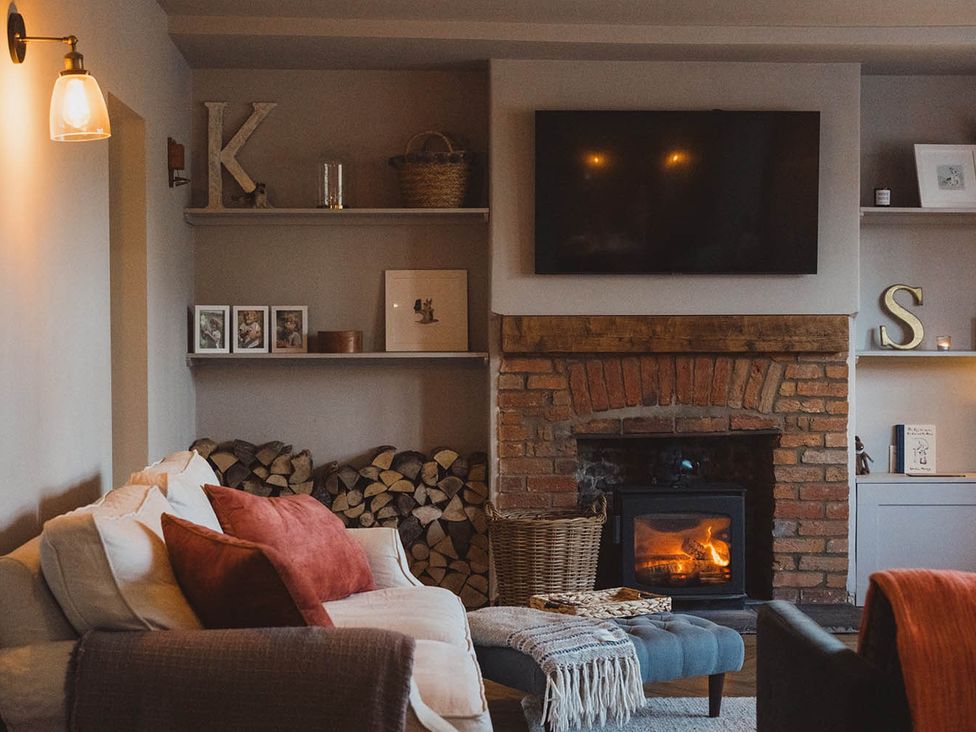 A living room with a fireplace and a television at the property in a location