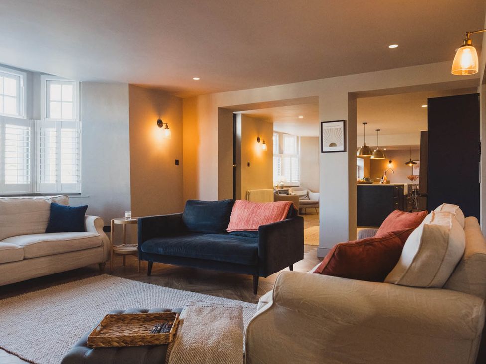 A living room with sofas and a table at The Old Barn in Manchester