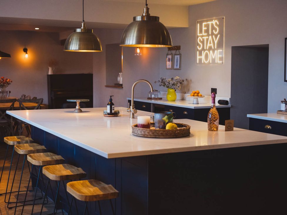 A kitchen with an island and seating at a property