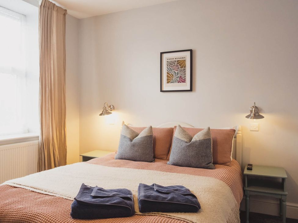 A bedroom with a bed and bedside table at The Old Barn in Manchester