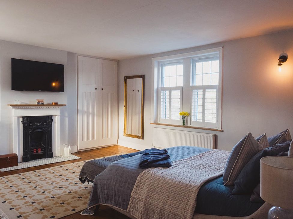 A bedroom with a bed and television at The Old Barn in Manchester