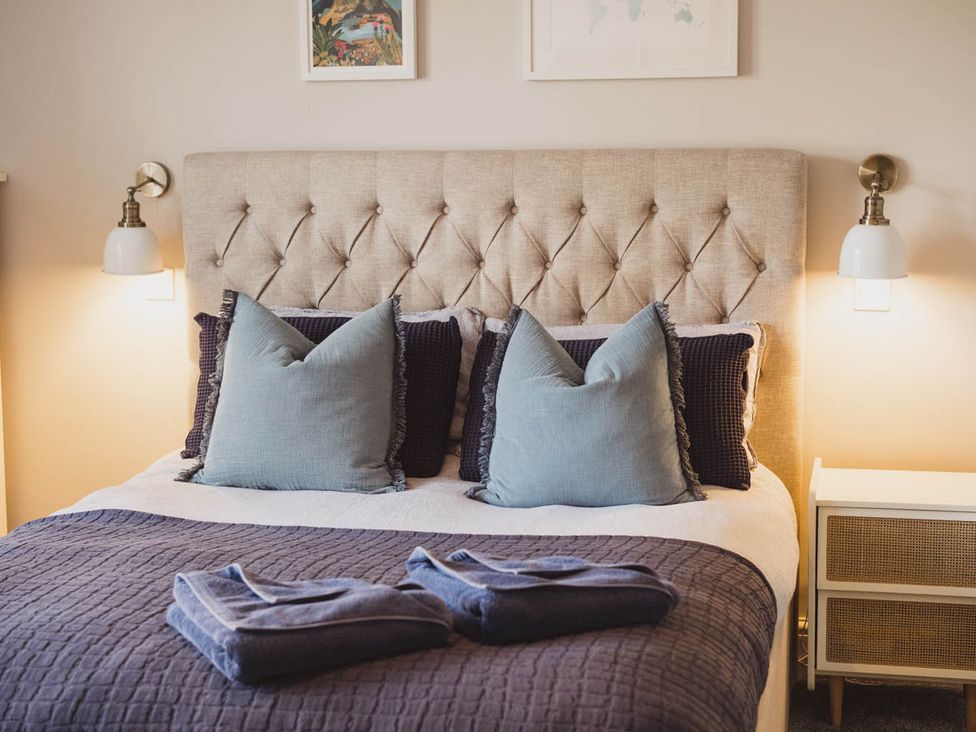 A bedroom with a bed and pillows at The Old Barn in Manchester