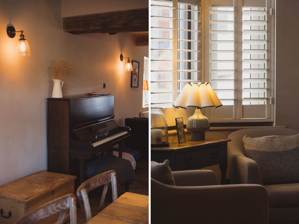 A living room with a piano and lamp at The Old Barn in Manchester