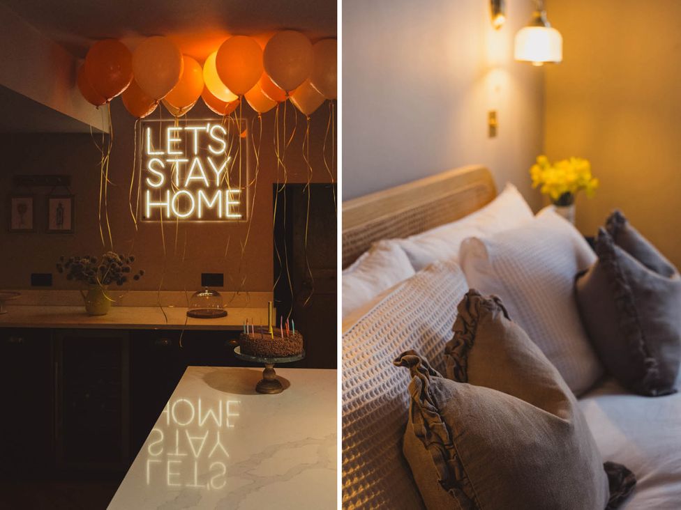 A kitchen with balloons and a neon sign at 