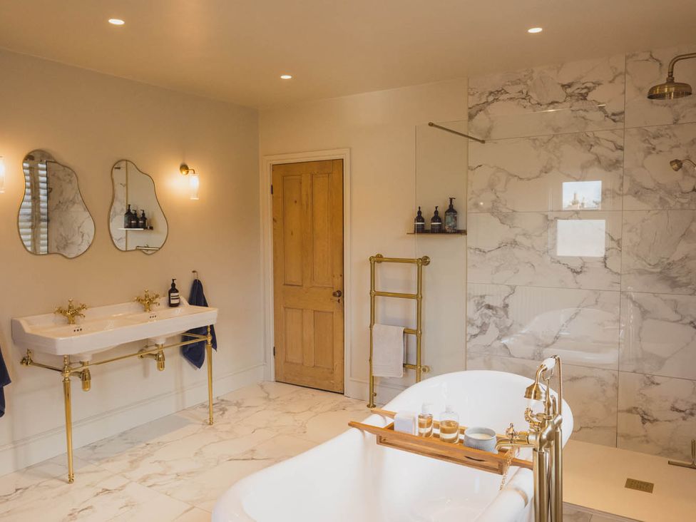A bathroom with a bathtub and sinks at 